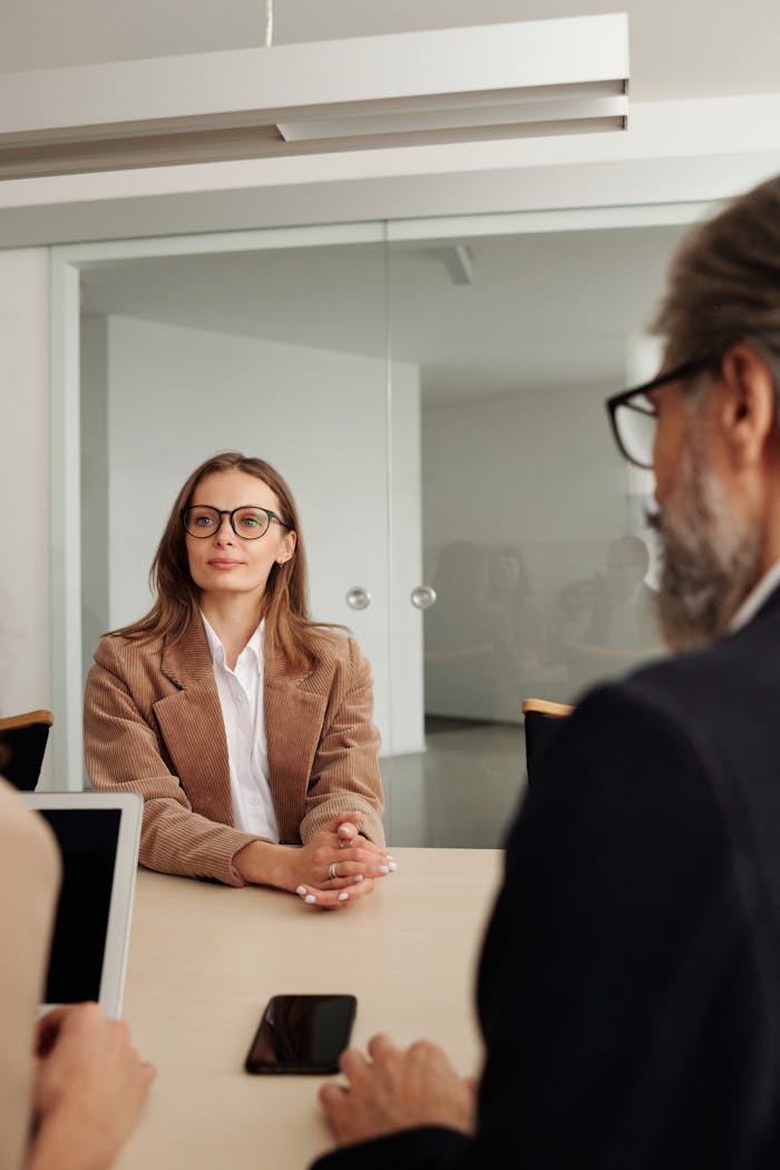 Business professionals engaged in a meeting in a modern office setting, focusing on collaboration and planning.
